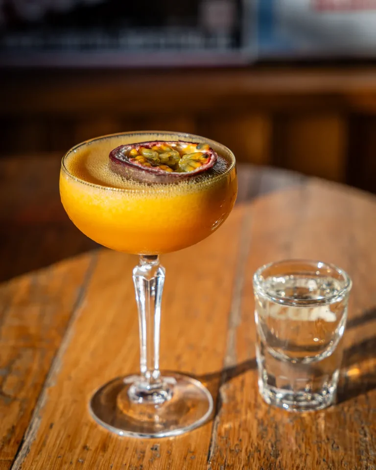 Cocktail met passievrucht op een houten tafel