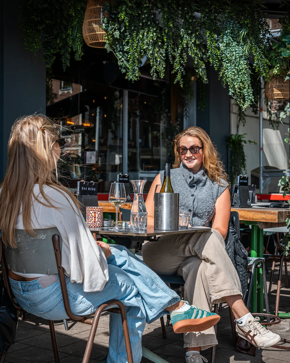 Twee gasten met wijn op het zonnige terras